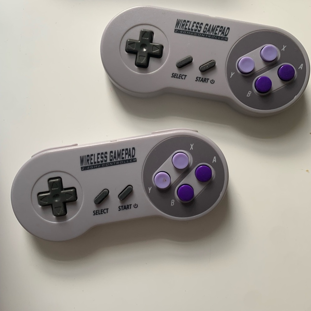 Two wireless Nintendo controllers SNES